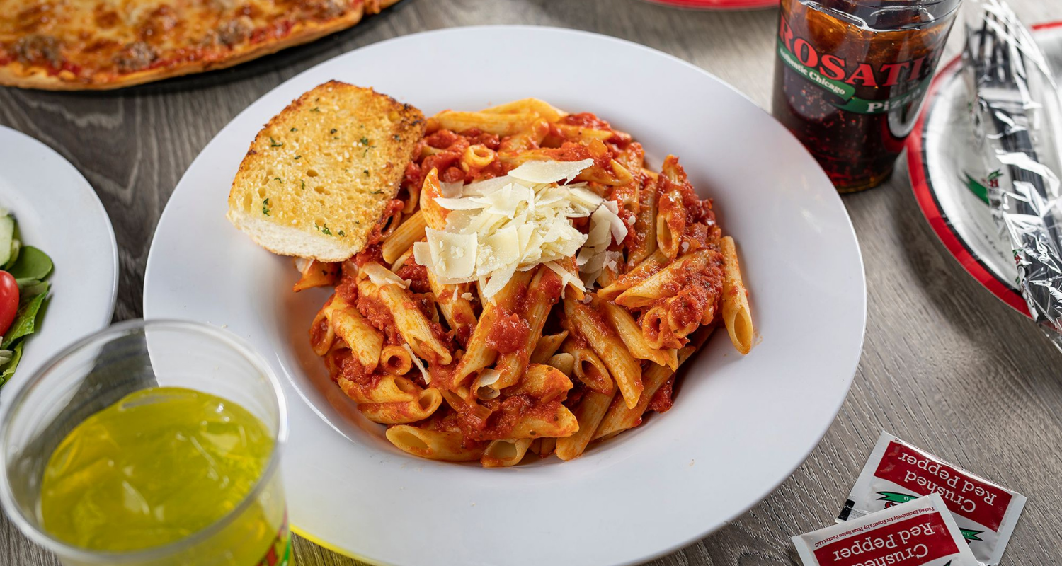 Penne pasta dish with bread.