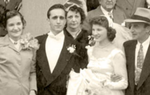 Black and white photo of multiple people in vintage wedding attire
