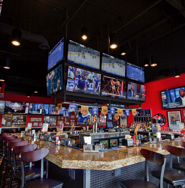 Picture of a Rosati's Pizza franchise Sports Pub with bar seating and sports on multiple T.V. screens